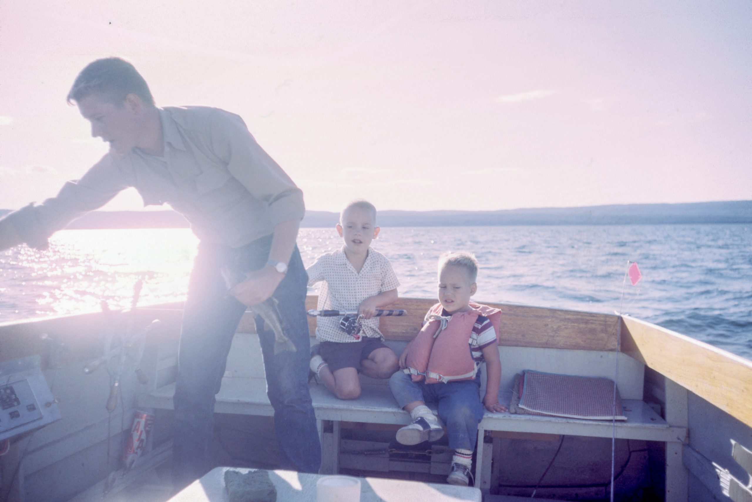 father fishing with boys